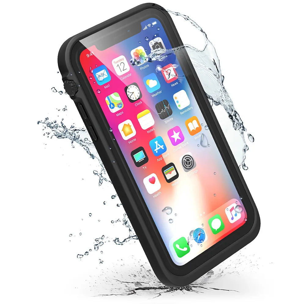 The iPhone Xs, protected by a Catalyst Case US Waterproof Case in Stealth Black, is splashed with water, showcasing its waterproof feature. The phone's screen shows colorful app icons and Sunday the 12th, set against a white background.