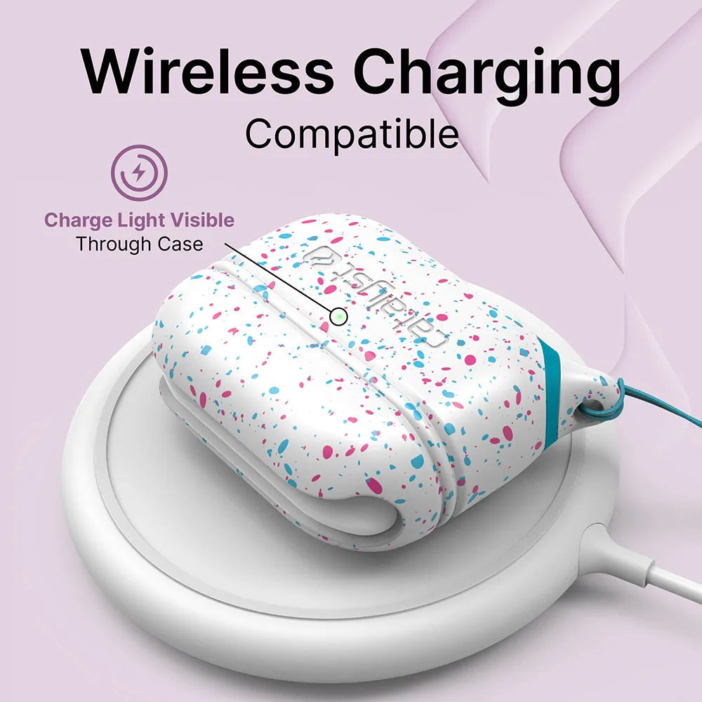 The Catalyst Case US AirPods Pro (Gen 2/1) Waterproof Case + Lanyard, shown with colorful pink and blue splatters, sits on a wireless charging pad. The charge light is visible through the case. Wireless charging compatible.