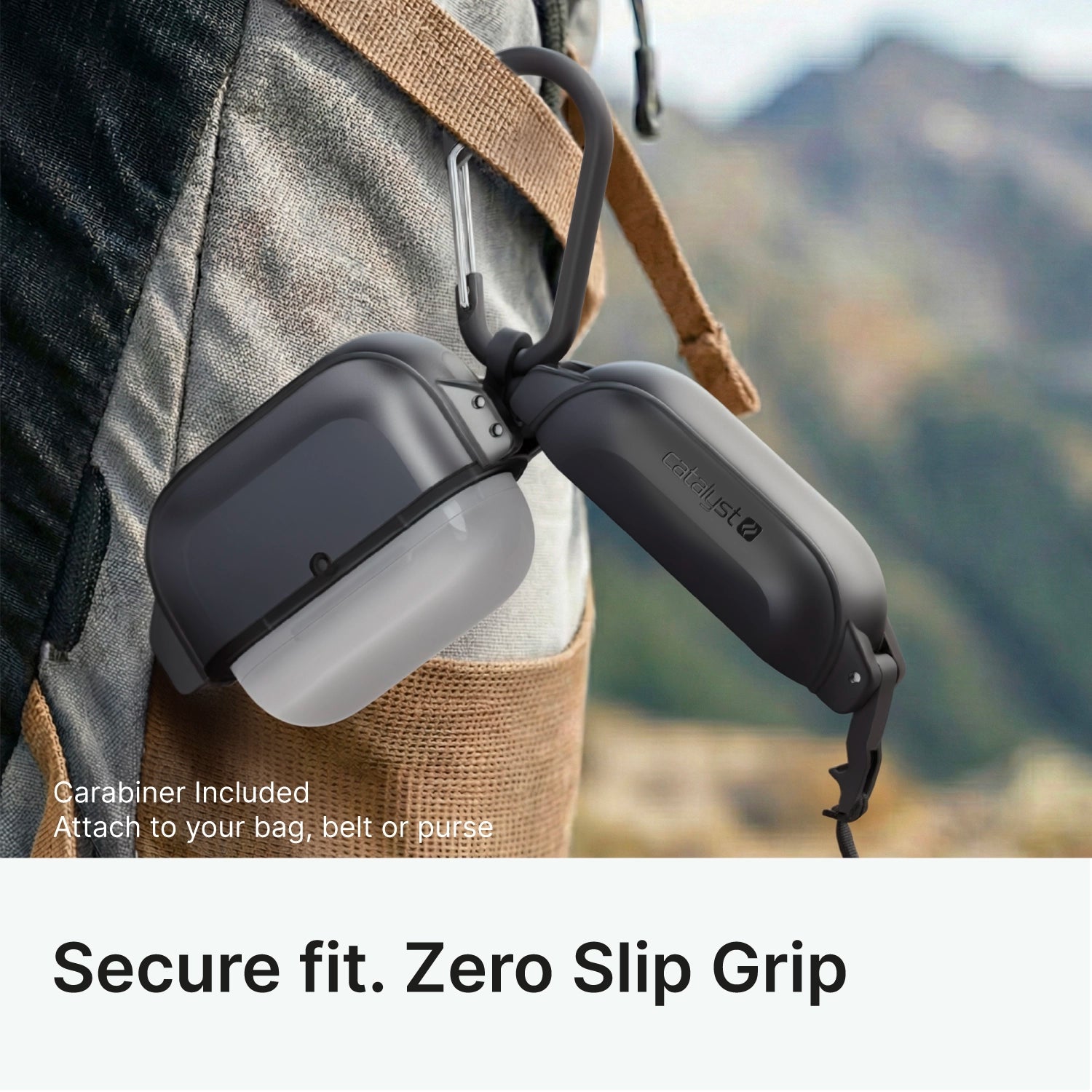Close-up of a Catalyst Case US AirPods Pro 3 - 100M Waterproof Total Protection Case + Carabiner in gray and black, attached to a backpack strap. The rugged case offers military-grade drop protection; blurred outdoor scenery in the background.