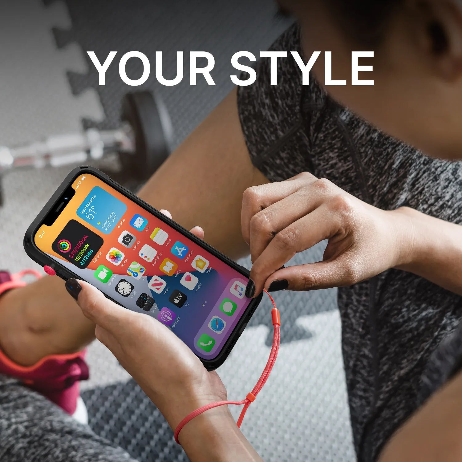 Wearing workout gear, a person sits on a gym mat using an iPhone with the Catalyst Case US Colored Lanyard & Buttons. The phone features a red wrist strap and colorful apps, with "YOUR STYLE" displayed above and a dumbbell in the background.