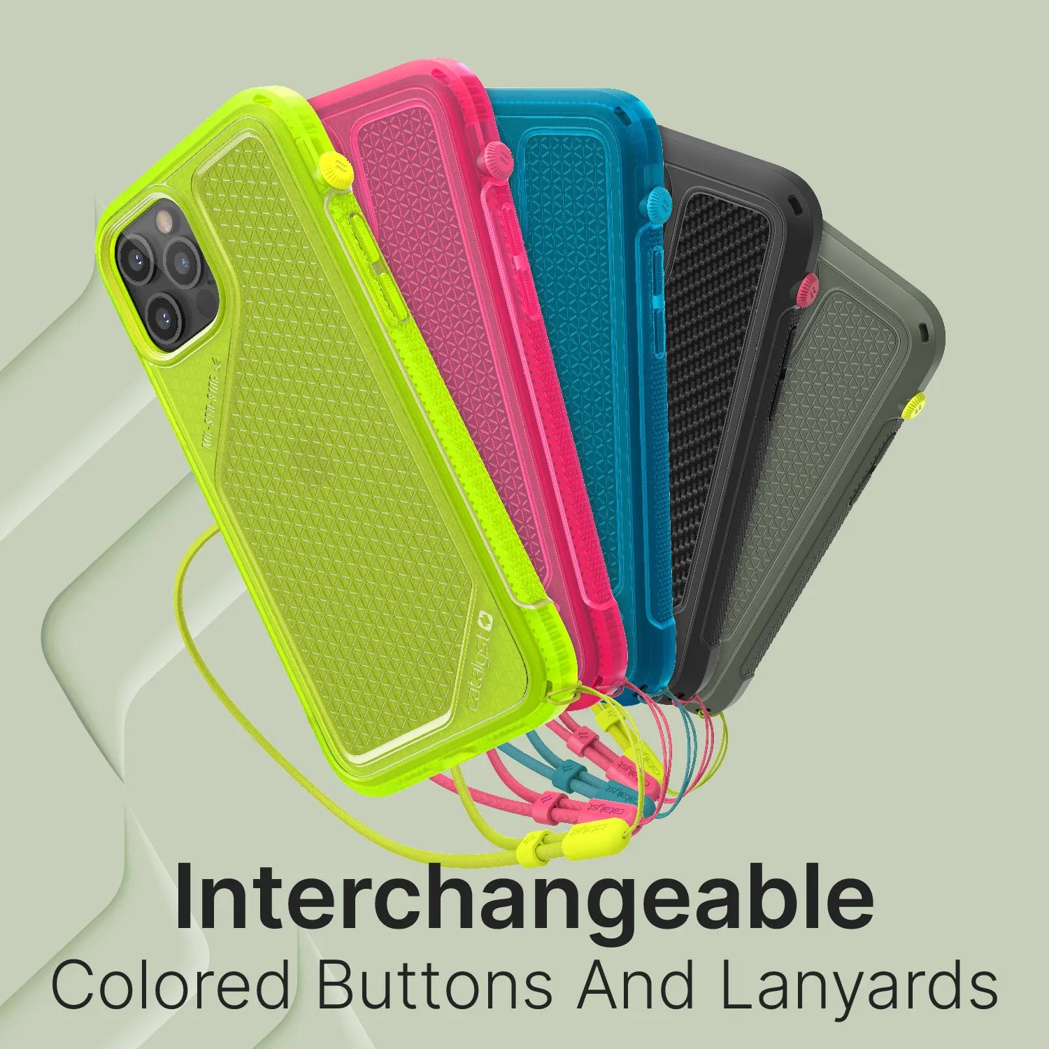 Five Catalyst Case US rugged cases in neon green, pink, blue, black, and grey with textured backs and matching lanyards fan out. Text: “Interchangeable Colored Lanyard & Buttons.” Light green background.