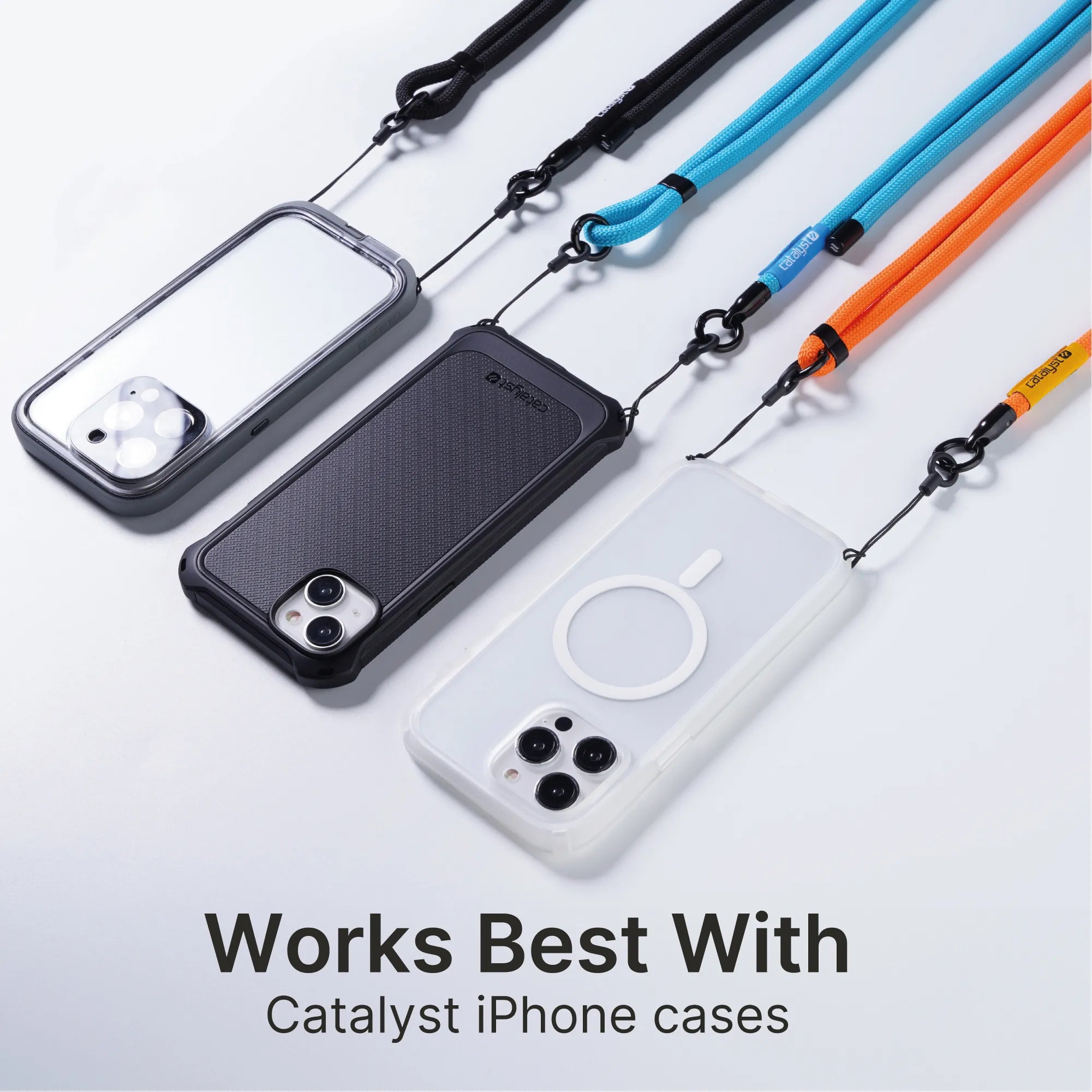 Three iPhones in durable Catalyst Case US coversâ€â€Âclear, black, and whiteâ€â€Âare attached to blue, teal, and orange Crossbody Shoulder Straps for hands-free use. Text: "Works Best With Catalyst Case US Crossbody Shoulder Strap." Clean white background.