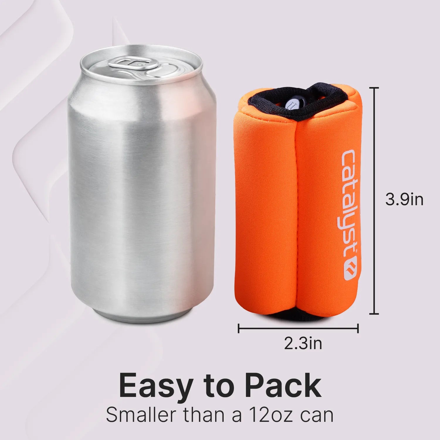 A plain silver 12oz can sits beside an upright, rolled-up orange Catalyst Case US Floating Wrist Lanyard pouch. At 3.9" tall and 2.3" wide, the pouch appears smaller than the can. Text reads: "Easy to Pack. Smaller than a 12oz can.