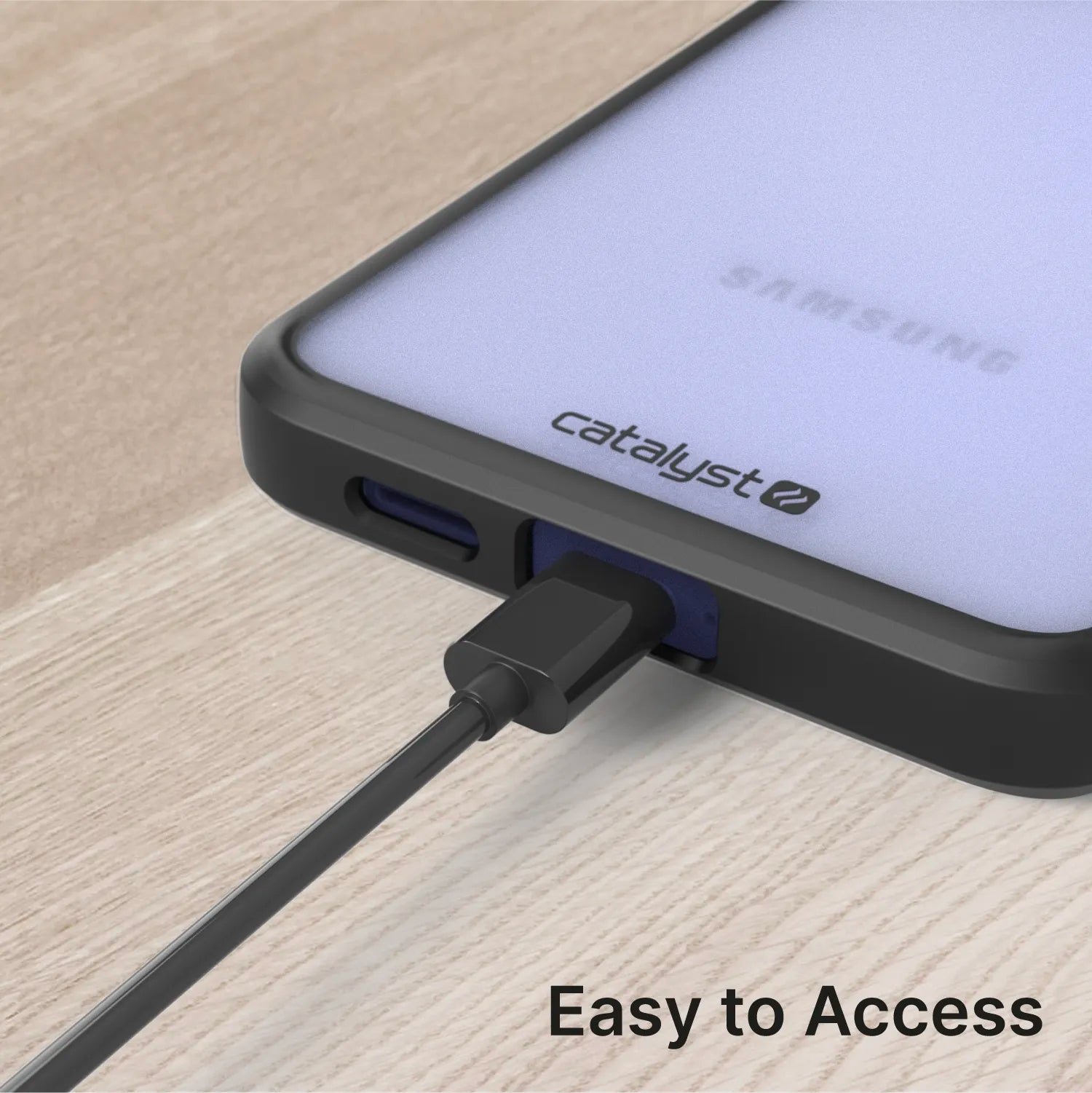 A black charging cable connects to a Samsung Galaxy S24 in a Catalyst Case US Impact Protection Case, resting on a wooden surface. The frosted back shows the Samsung logo. “Easy to Access” text appears in the bottom right corner.
