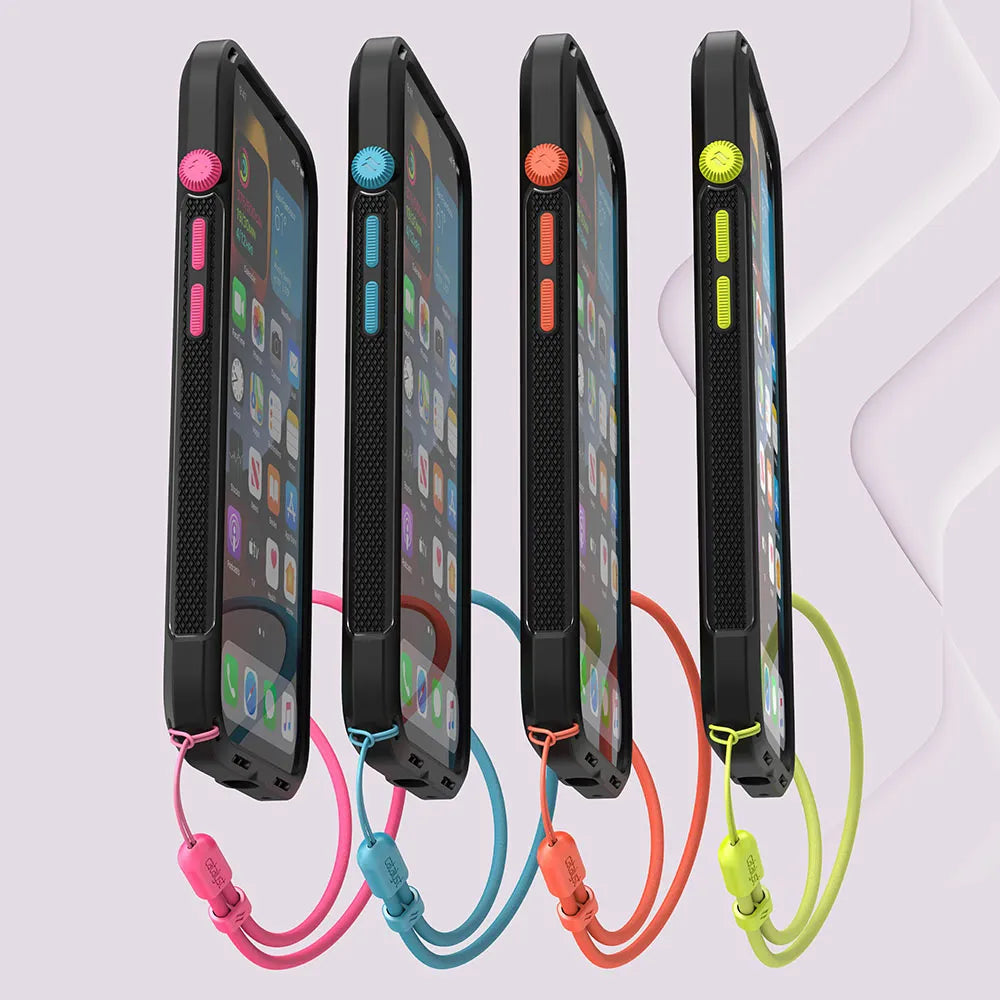Four iPhone 13 devices in Catalyst Case US Vibe Cases (MagSafe Compatible) stand upright, each case black with a colored button and matching wrist lanyard—pink, blue, orange, or green—while displaying app-filled home screens.