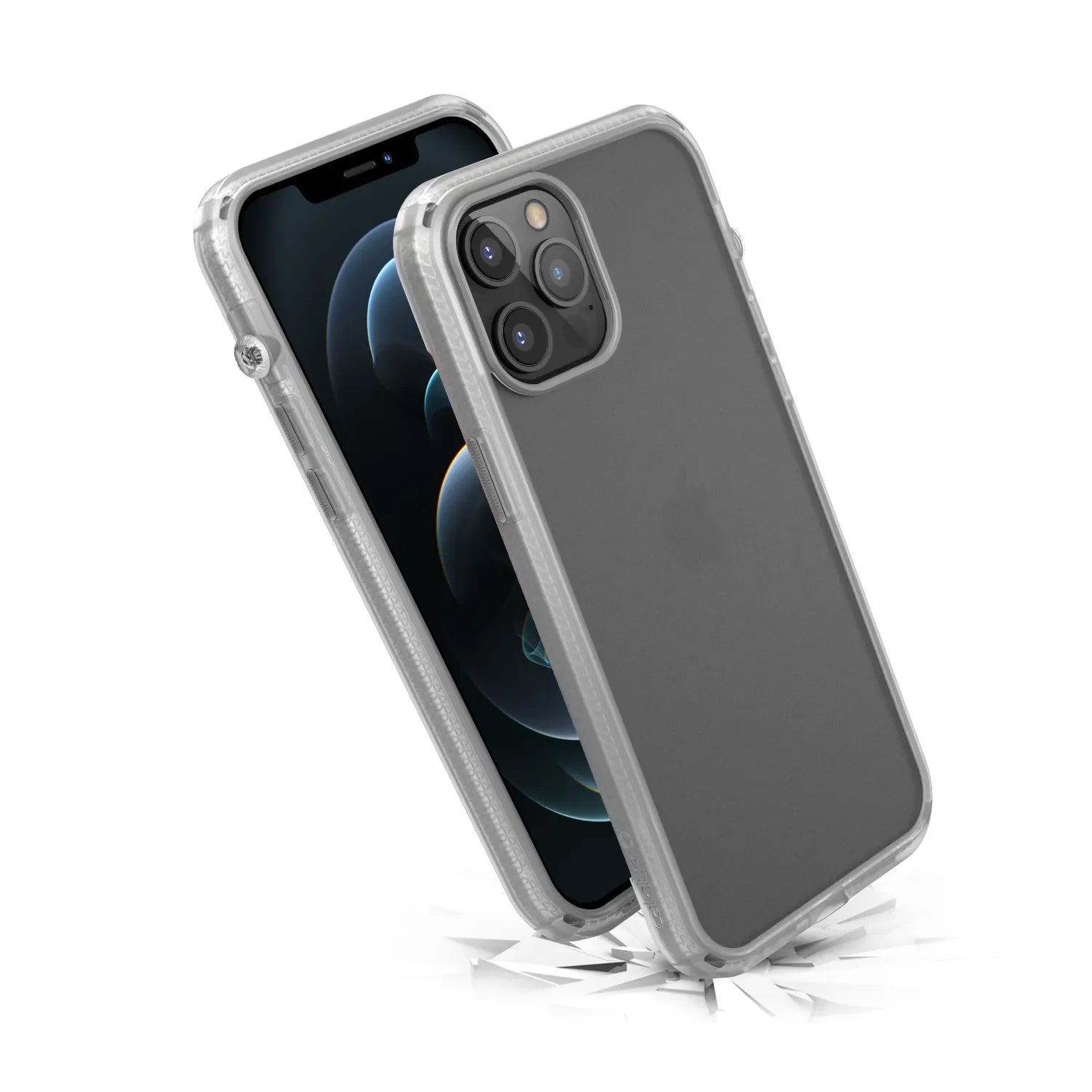 The Catalyst Case US Influence Case for iPhone 12 Pro Max is shown with a triple-lens camera and black screen in a clear protective case. The phone is angled upward on cracked ground, showing its MIL-STD 810G drop proof durability and wireless charging compatibility.