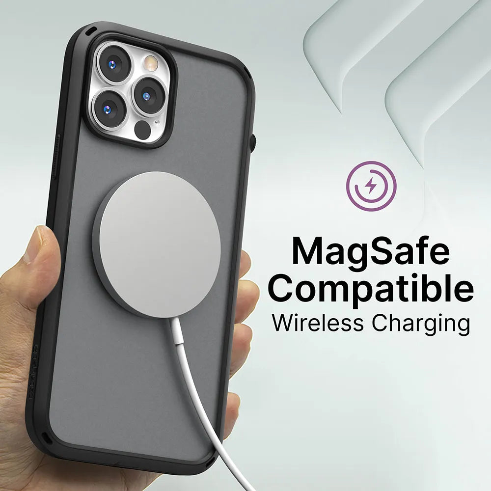 A hand holds an iPhone 13 mini in a gray, drop-proof Catalyst Case US Influence Case with a circular MagSafe wireless charger attached. Beside the phone, text reads "MagSafe Compatible Wireless Charging" with a charging icon above it.