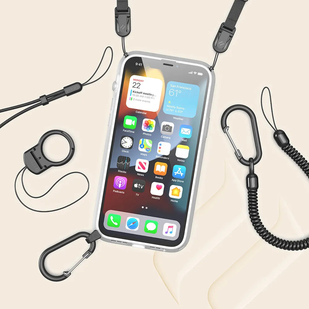 The Catalyst Case US iPhone 13 Pro Max - Influence Case, transparent and drop proof, with a black lanyard attached at two points, is shown surrounded by black accessories: coiled tether, carabiners, wrist strap, and ring holder on a beige background.