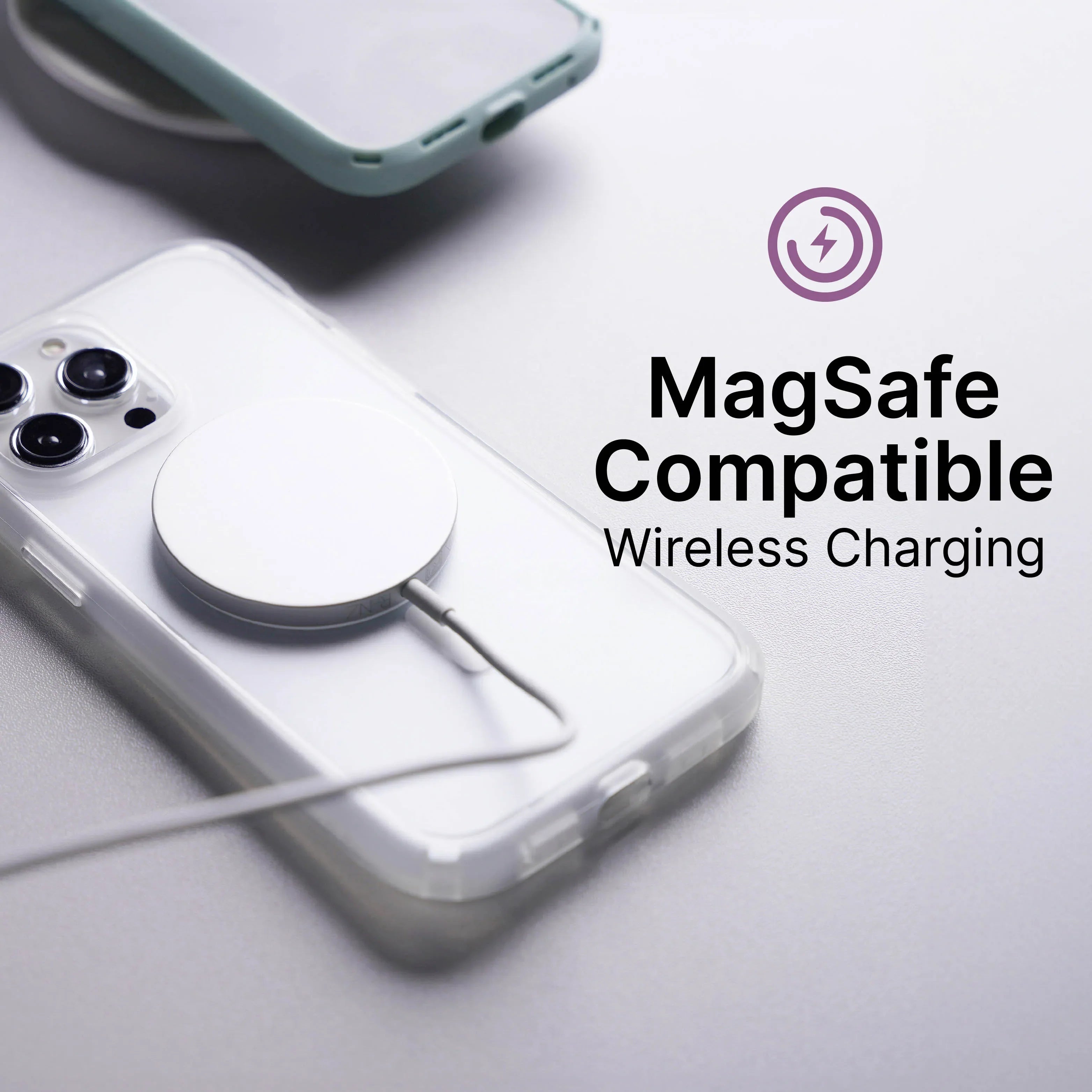 An iPhone 14 Plus in a transparent Catalyst Case US Influence Case is on a flat surface, connected to a MagSafe wireless charger. Another phone rests nearby. Text reads: “MagSafe Compatible Wireless Charging” with a charging icon above.