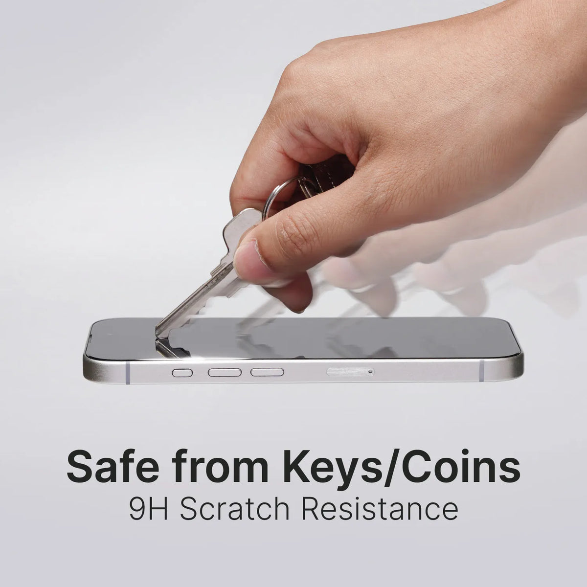 A hand drags a silver key across an iPhone 16 Pro Max with the Catalyst Case US Tempered Glass Screen Protector, showing its 9H scratch resistance. The phone, with a silver frame, rests on a white surface. Text: “Safe from Keys/Coins.”.