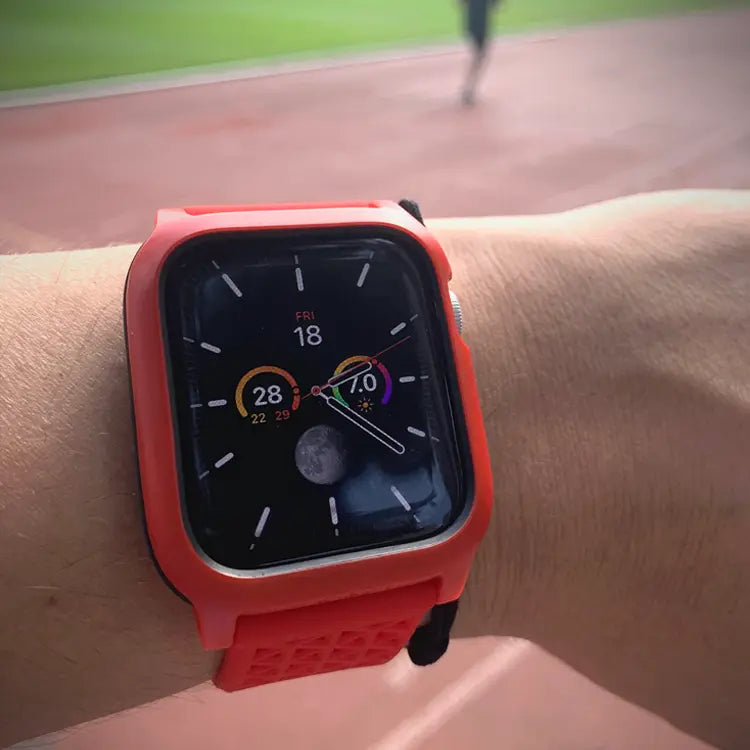 A close-up shows a Catalyst Case US 44mm Rugged Case + Band for Apple Watch Series 6/5/4/SE with a red strap. The display shows the date, activity rings, weather, and moon phase. A running track and person appear blurred in the backgroundÃƒÂ¢Ã¢â€šÂ¬Ã¢â‚¬Âperfect for fitness fans.