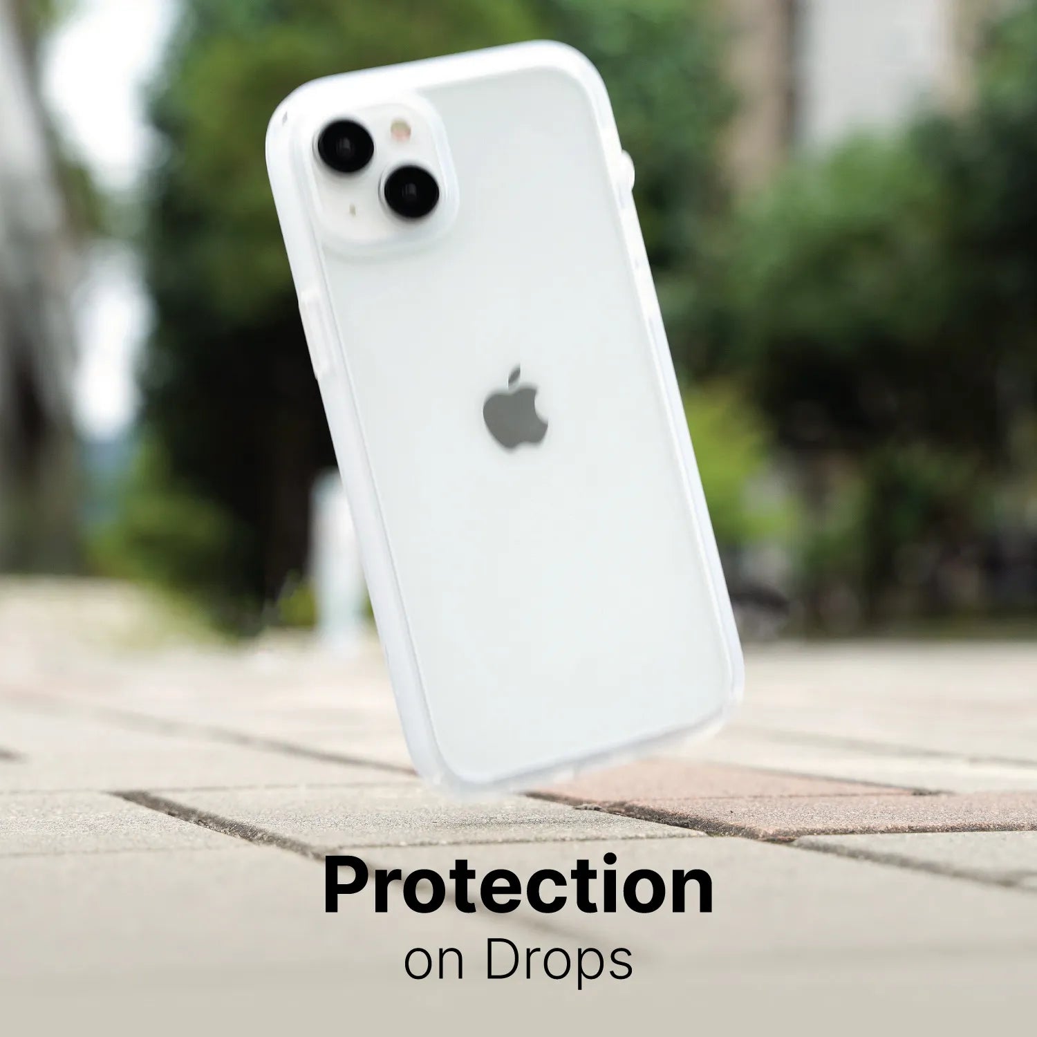 A white iPhone 15 Pro with the Catalyst Case US Influence Case (MagSafe compatible) appears mid-air over stone pavement, with blurred trees and buildings behind. Text reads “Protection on Drops,” highlighting the case’s drop protection.