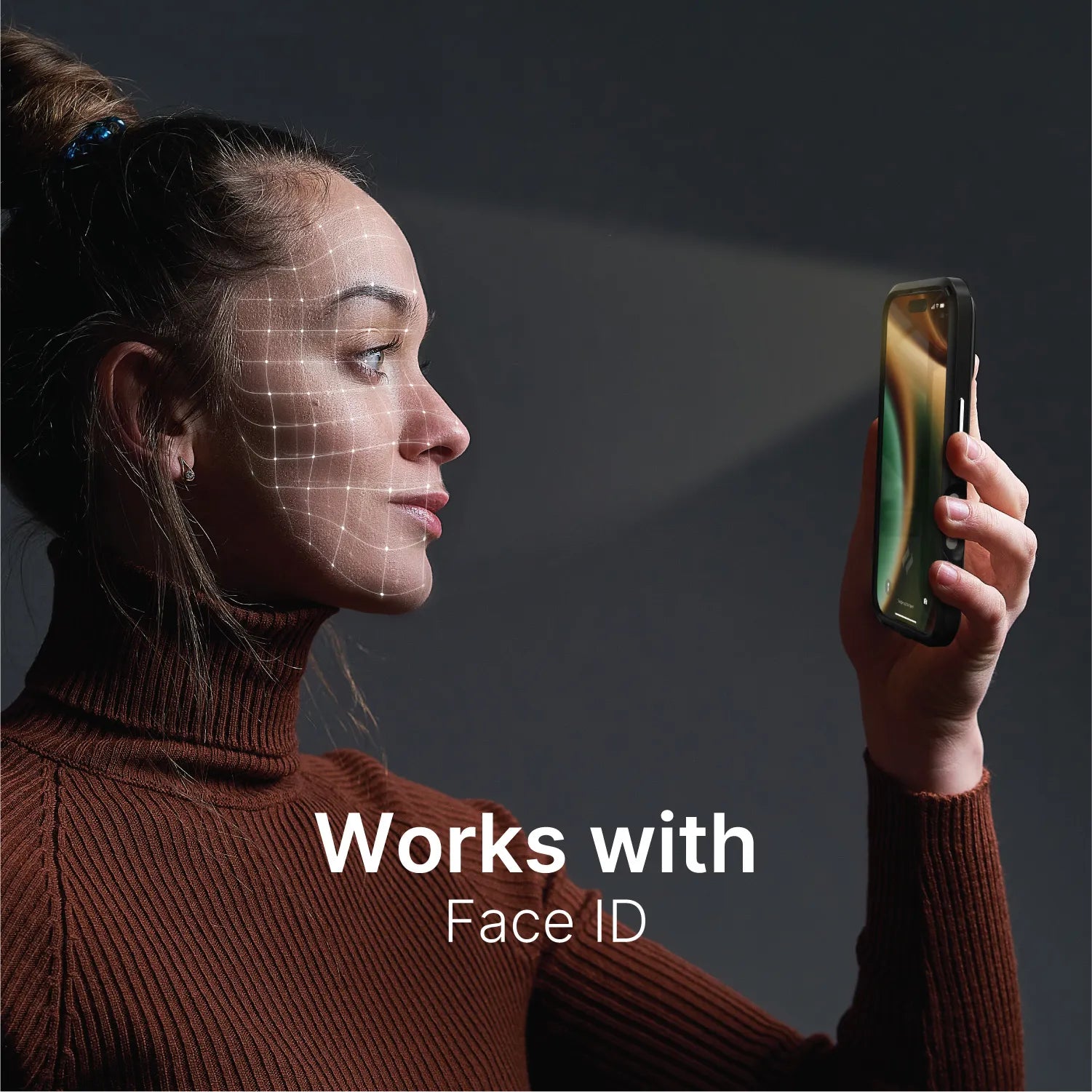 A woman in a brown turtleneck holds an iPhone 13 mini with a Catalyst Case US Tempered Glass Screen Protector at face level as facial recognition scans, and the text below reads, "Works with Face ID.