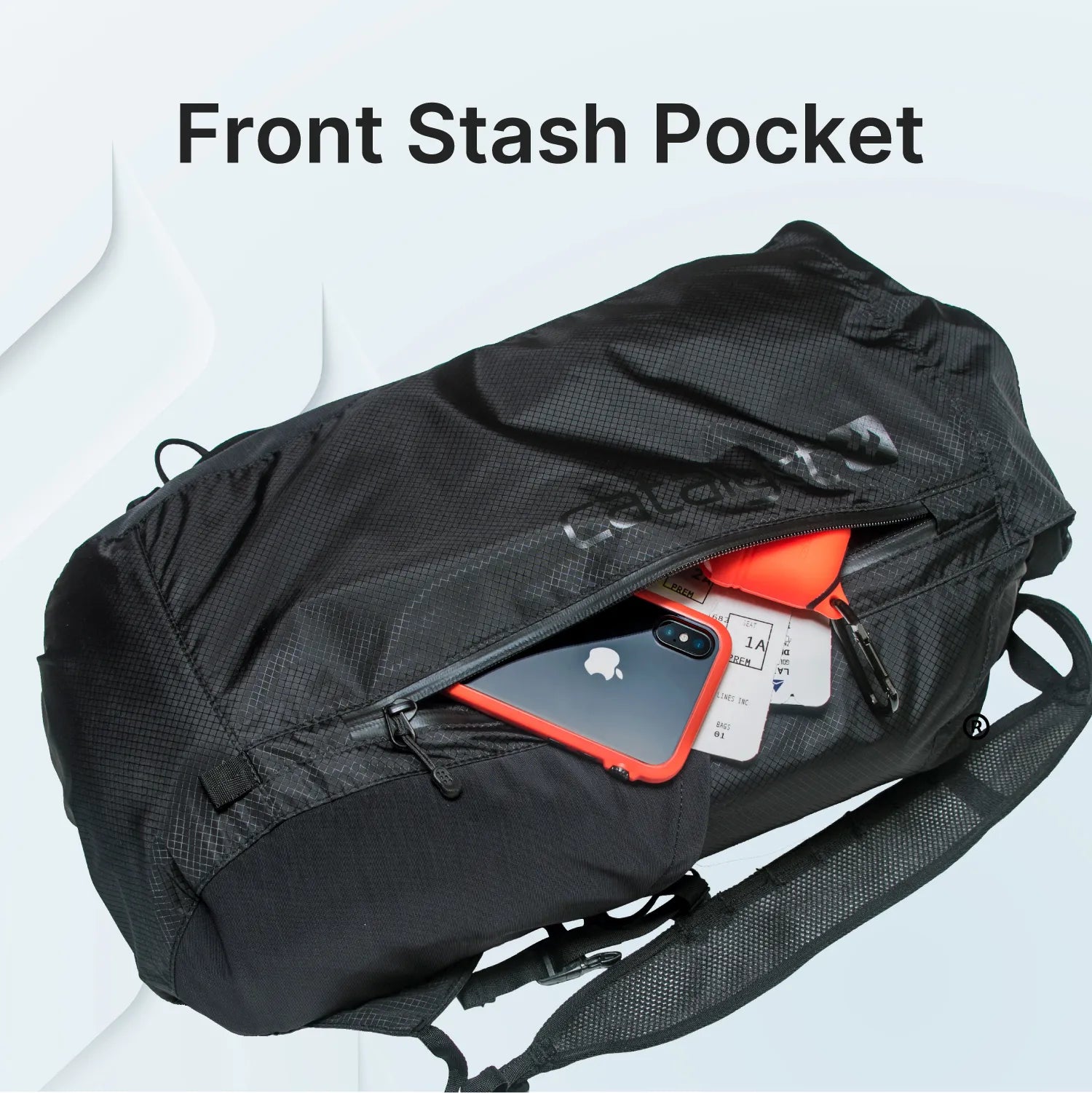 The Catalyst Case US Waterproof 20L Backpack features a textured, durable fabric, adjustable strap, and a front stash pocket with a partially open zipper showing a smartphone, orange wallet, and white cards. “Front Stash Pocket” is written above in bold black letters.