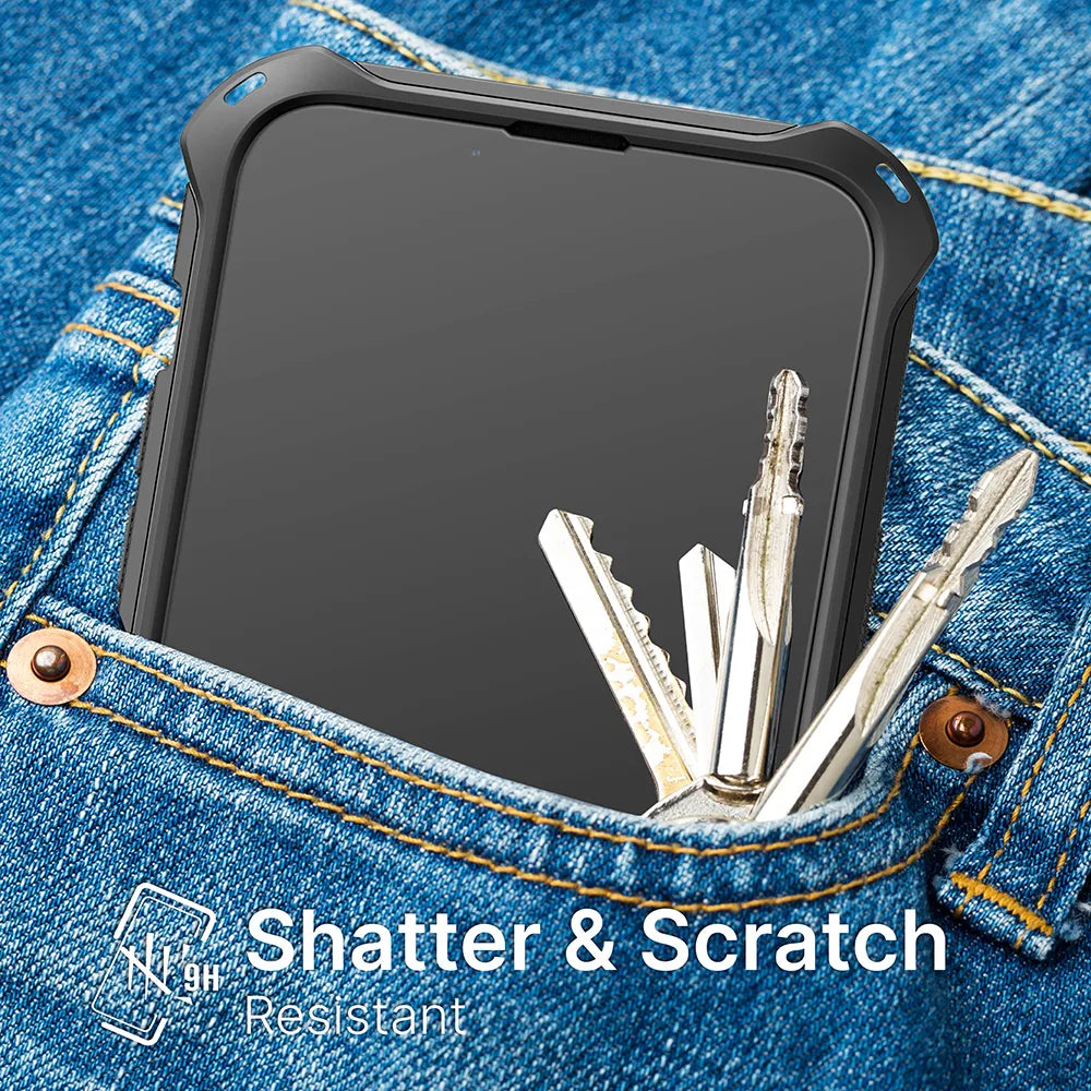 An iPhone 12 Pro Max with a Catalyst Case US Tempered Glass Screen Protector rests in a denim jeans pocket next to three metal keys. White text reads “Shatter & Scratch Resistant” with a shield icon and “9H” hardness rating.