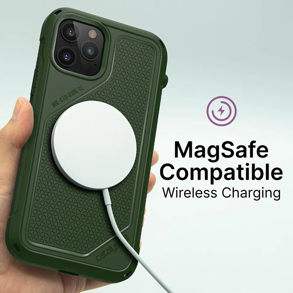 A hand holds an iPhone 12 Pro Max in a rugged, textured green Catalyst Case US Vibe Case, with a round white MagSafe wireless charger attached. On the right: “MagSafe Compatible Wireless Charging” beside a purple charging icon.