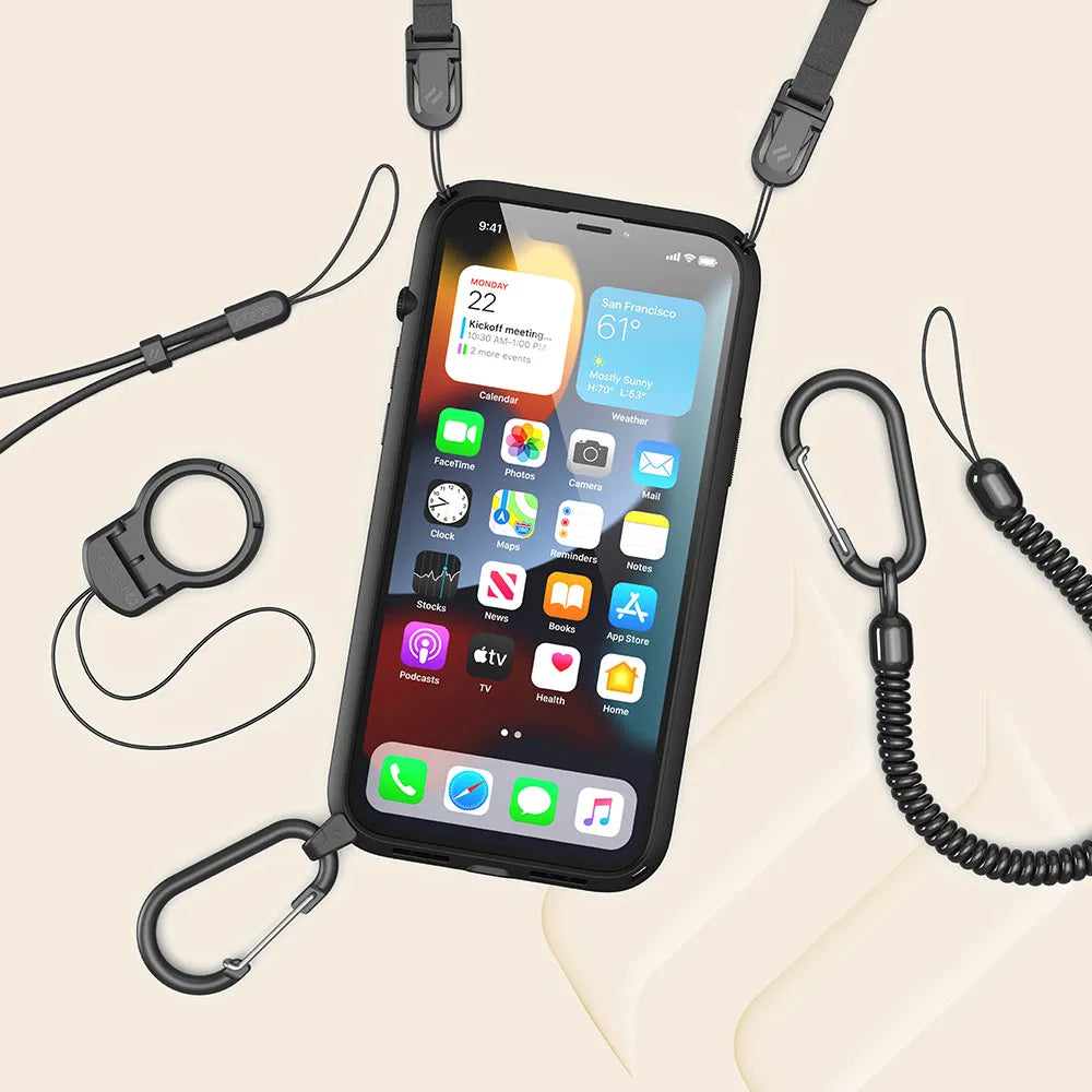 The iPhone 13 in a black Catalyst Case US Influence Case, featuring MIL-STD 810G drop protection, lanyard, clips, coiled tether, carabiners, and a secure phone holder on a beige surface. The screen displays app icons and weather information.