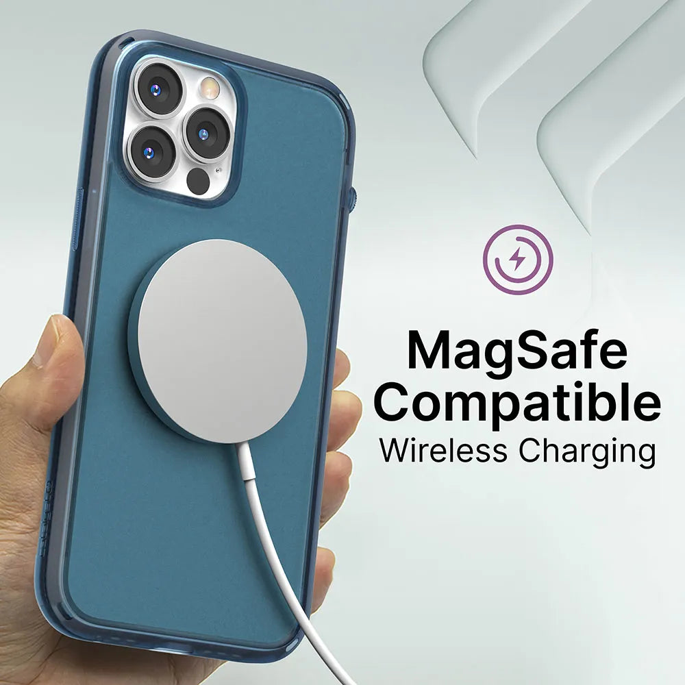 A hand holds an iPhone 13 Pro in a transparent, drop-proof Catalyst Case US Influence Case. A circular MagSafe wireless charger is attached. Text reads "MagSafe Compatible Wireless Charging" with a purple charging icon above.