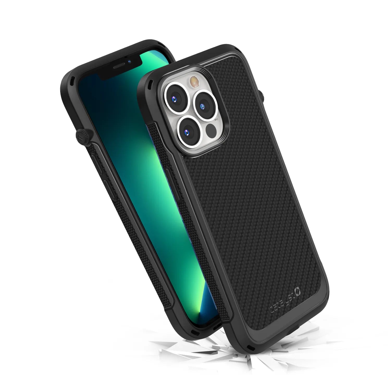 Two iPhone 13 Pro devices in Catalyst Case US Vibe Cases, Stealth Black, with rugged textured MagSafe-compatible protection. One shows the screen; the other reveals three camera lenses. Glass shards below suggest drop protection.