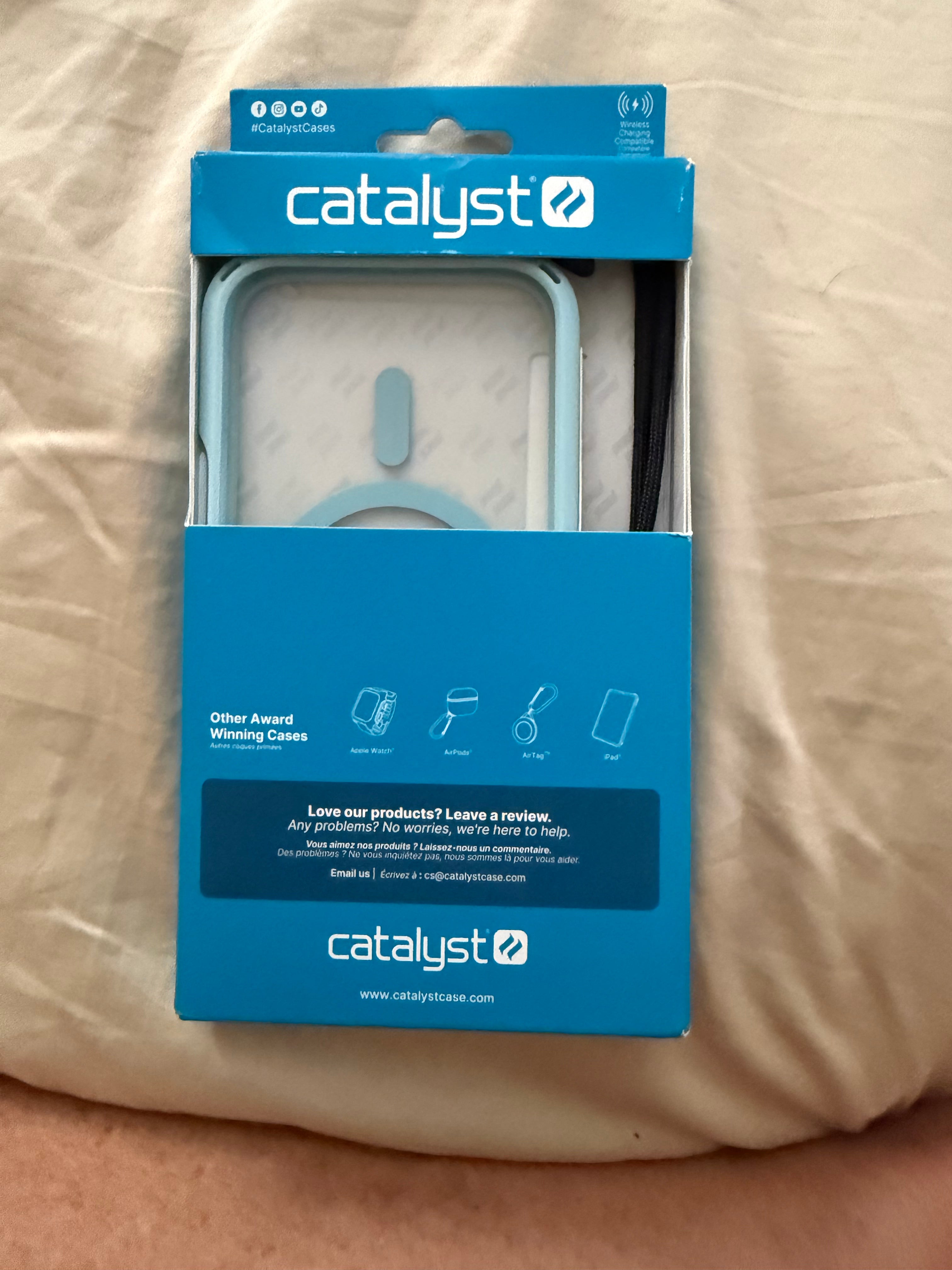 A Catalyst Case US Influence Case for iPhone 16 Pro, MagSafe Compatible, in Sky Blue, is displayed in blue and white packaging on a beige surface. The box showcases its award-winning military-grade drop protection, and features contact information, social media links, and a partially visible instruction card inside. The Catalyst logo appears prominently at both the top and bottom of the package.